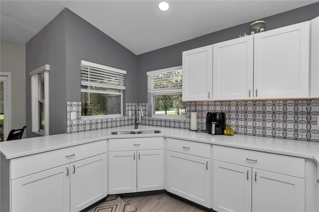 8198 N Brook Way, Citrus Springs, FL 34433 - kitchen featuring light countertops, white cabinetry, decorative backsplash, recessed lighting, and vaulted ceiling