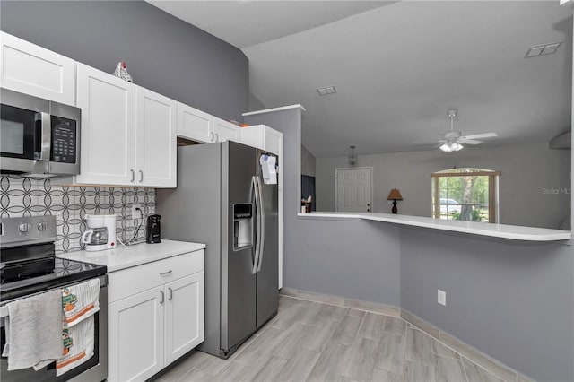 8198 N Brook Way, Citrus Springs, FL 34433 - kitchen featuring appliances with stainless steel finishes, white cabinets, light countertops, a ceiling fan, and decorative backsplash