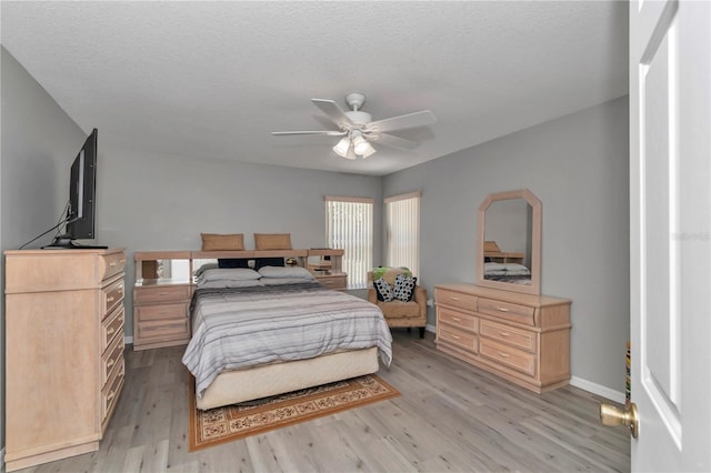 8198 N Brook Way, Citrus Springs, FL 34433 - bedroom featuring light wood-style flooring, ceiling fan, and a textured ceiling