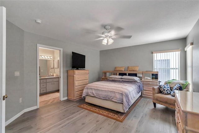 8198 N Brook Way, Citrus Springs, FL 34433 - bedroom featuring wood finished floors, ensuite bathroom, and ceiling fan