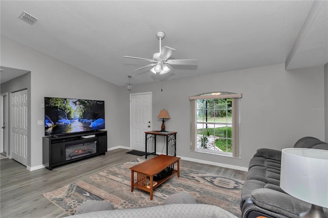 8198 N Brook Way, Citrus Springs, FL 34433 - living room featuring wood finished floors, a ceiling fan, and lofted ceiling