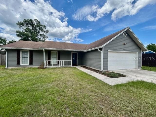 3372 Penny Ln, Middleburg, FL 32068 - ranch-style home with covered porch, an attached garage, a front yard, and concrete driveway