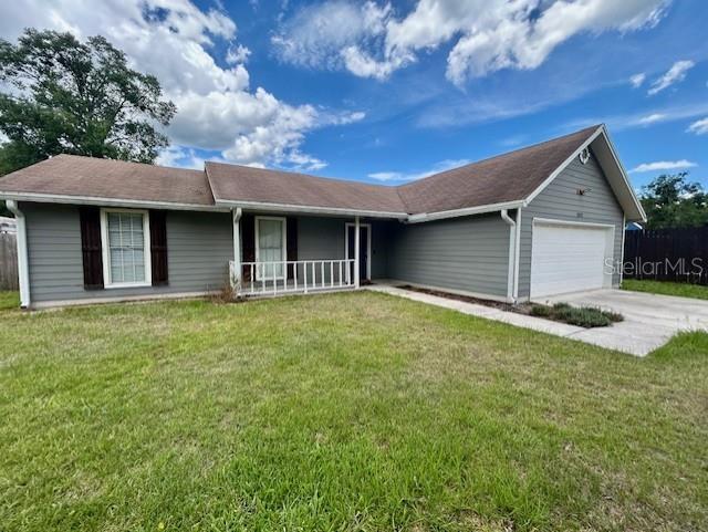 3372 Penny Ln, Middleburg, FL 32068 - ranch-style house featuring an attached garage, covered porch, and a front lawn