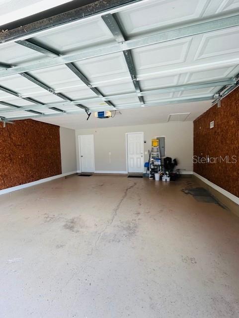 3372 Penny Ln, Middleburg, FL 32068 - garage with a garage door opener and baseboards