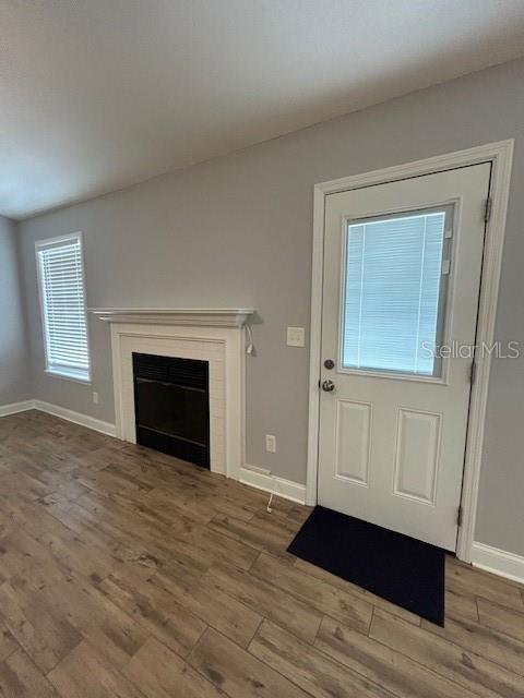 3372 Penny Ln, Middleburg, FL 32068 - unfurnished living room featuring wood finished floors and a fireplace
