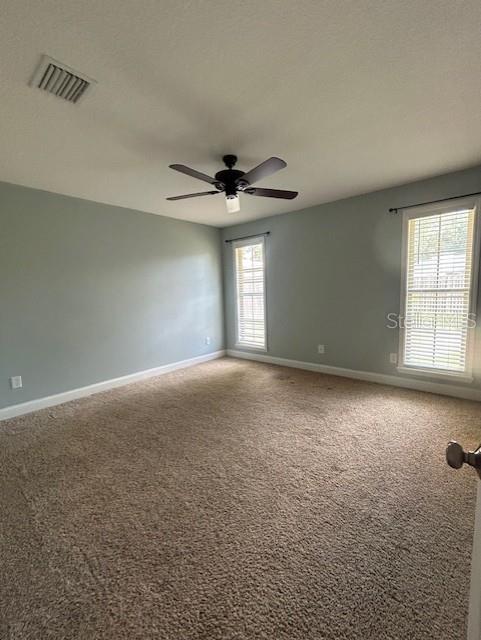 3372 Penny Ln, Middleburg, FL 32068 - spare room featuring carpet and a ceiling fan