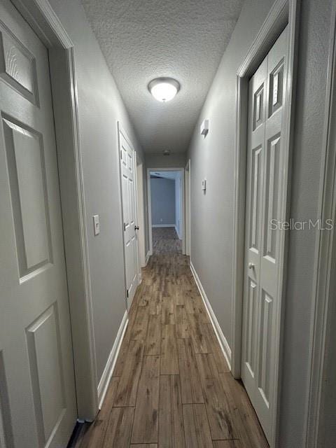 3372 Penny Ln, Middleburg, FL 32068 - corridor featuring dark wood-style floors and a textured ceiling
