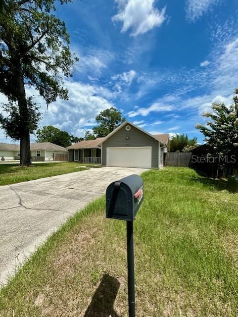3372 Penny Ln, Middleburg, FL 32068 - ranch-style home with a garage and concrete driveway