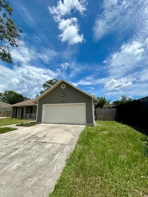 3372 Penny Ln, Middleburg, FL 32068 - view of side of home with concrete driveway and a garage