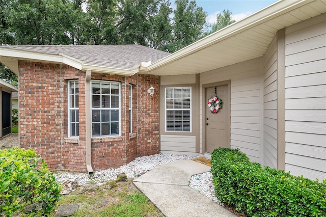 4814 NW 75th Rd, Gainesville, FL 32653 - view of exterior entry with roof with shingles and brick siding