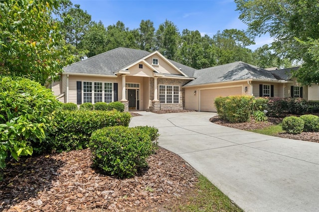 6326 SW 90th St, Gainesville, FL 32608 - view of front of property with an attached garage, driveway, stone siding, and a shingled roof