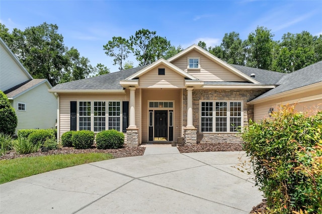 6326 SW 90th St, Gainesville, FL 32608 - craftsman inspired home with stone siding and a shingled roof