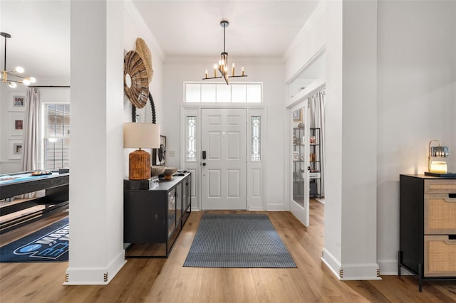 6326 SW 90th St, Gainesville, FL 32608 - entrance foyer featuring a chandelier, crown molding, wood finished floors, and a towering ceiling