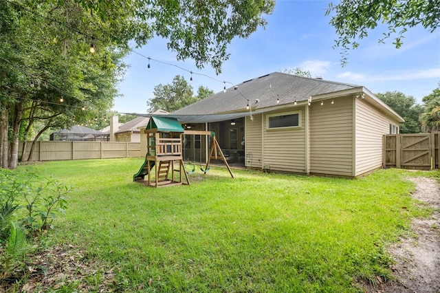 6326 SW 90th St, Gainesville, FL 32608 - back of house featuring a playground, a fenced backyard, and roof with shingles