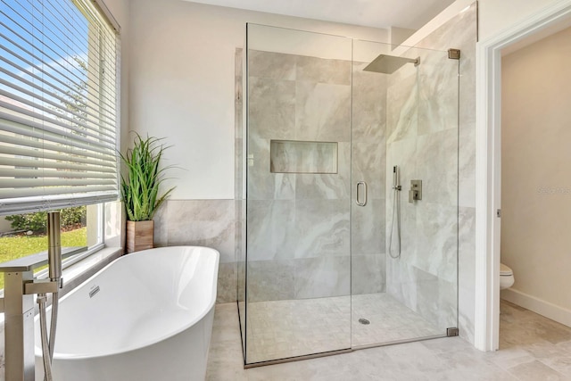 6364 Golden Eye Gln, Lakewood Ranch, FL 34202 - full bathroom featuring a freestanding tub, a stall shower, and tile patterned floors