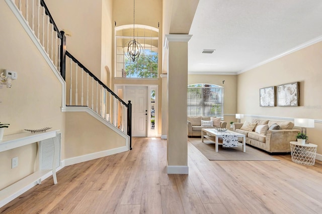 6364 Golden Eye Gln, Lakewood Ranch, FL 34202 - entryway with a chandelier, stairway, wood finished floors, ornamental molding, and a high ceiling