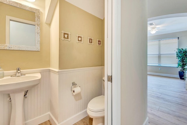 6364 Golden Eye Gln, Lakewood Ranch, FL 34202 - half bathroom with a wainscoted wall, wood finished floors, and ceiling fan