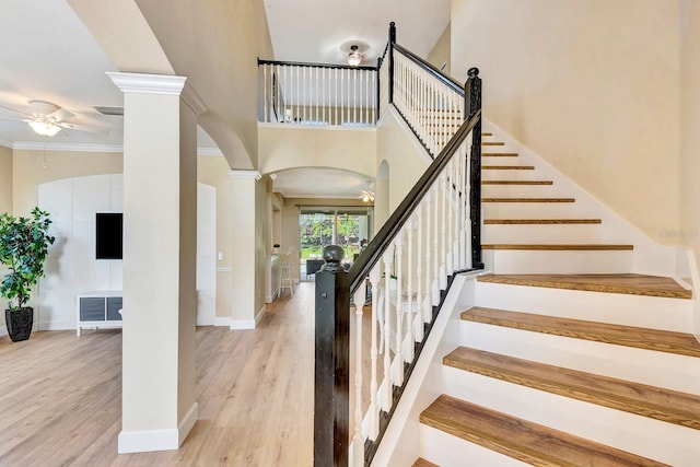 6364 Golden Eye Gln, Lakewood Ranch, FL 34202 - stairs featuring ceiling fan, arched walkways, wood finished floors, crown molding, and ornate columns
