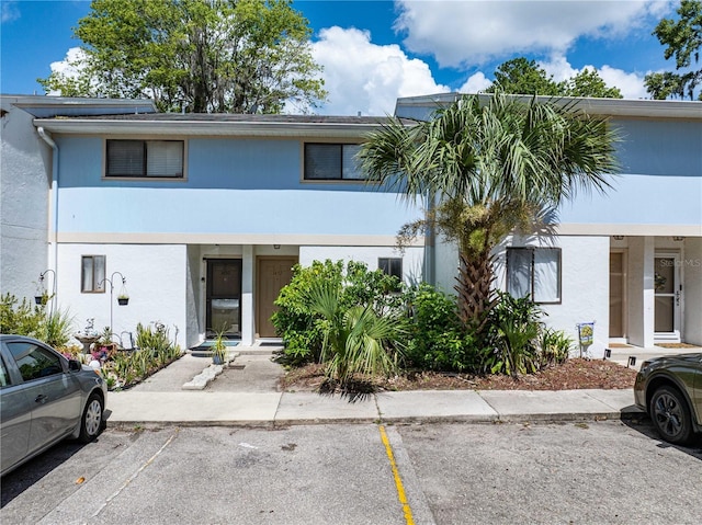 1452 SW 25th Pl Unit D4, Gainesville, FL 32608 - townhome / multi-family property with uncovered parking and stucco siding