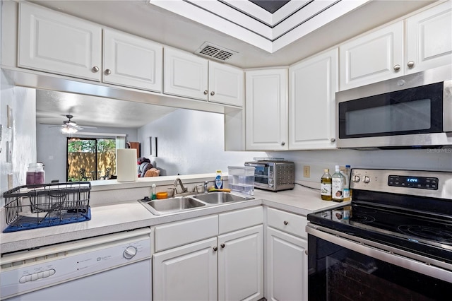 1452 SW 25th Pl Unit D4, Gainesville, FL 32608 - kitchen featuring appliances with stainless steel finishes, white cabinets, light countertops, and ceiling fan