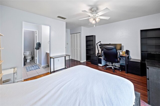 1452 SW 25th Pl Unit D4, Gainesville, FL 32608 - bedroom featuring an office area, a closet, wood finished floors, and ensuite bath