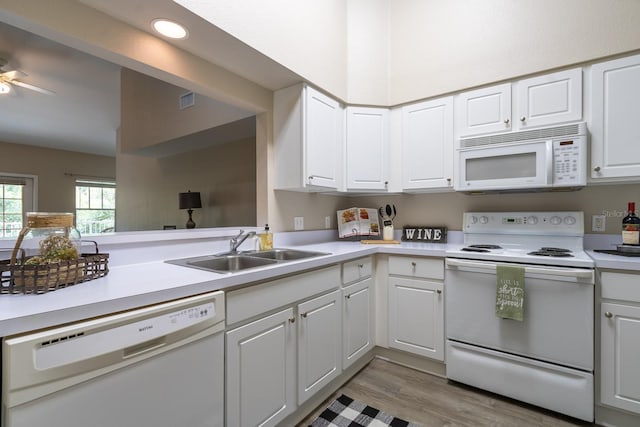 9177 SW 52nd Rd Unit E302, Gainesville, FL 32608 - kitchen with white appliances, light countertops, white cabinetry, light wood finished floors, and a ceiling fan