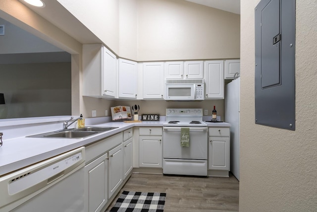 9177 SW 52nd Rd Unit E302, Gainesville, FL 32608 - kitchen featuring white appliances, electric panel, wood finished floors, white cabinetry, and light countertops