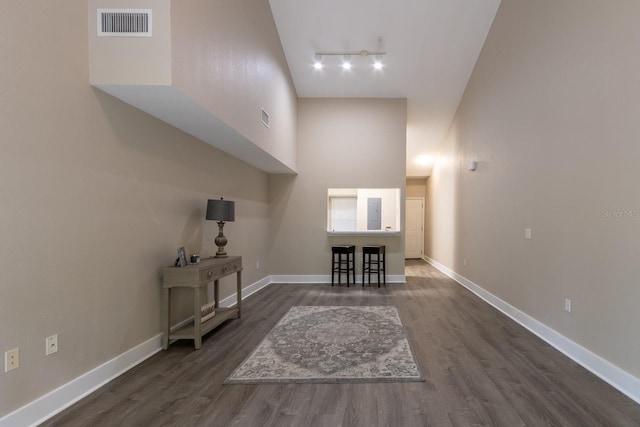 9177 SW 52nd Rd Unit E302, Gainesville, FL 32608 - living room with dark wood-type flooring, a towering ceiling, track lighting, and electric panel
