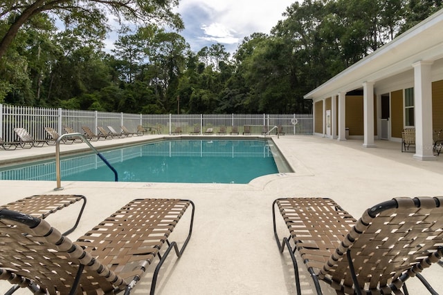 9177 SW 52nd Rd Unit E302, Gainesville, FL 32608 - community pool featuring a patio and view of scattered trees