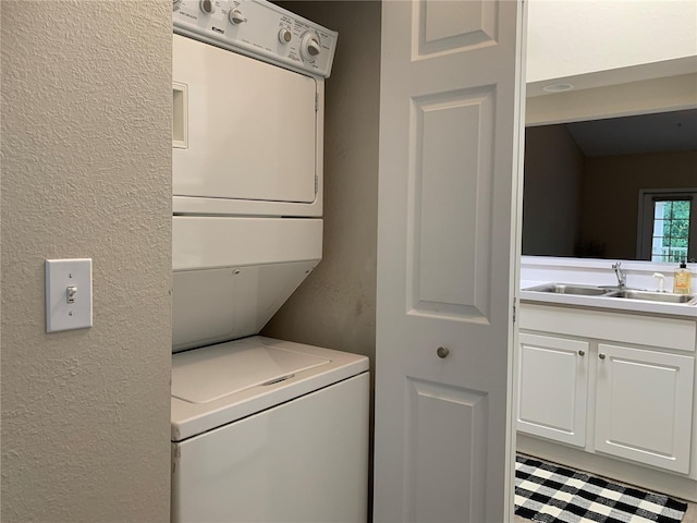 9177 SW 52nd Rd Unit E302, Gainesville, FL 32608 - laundry room with stacked washer / dryer and a textured wall