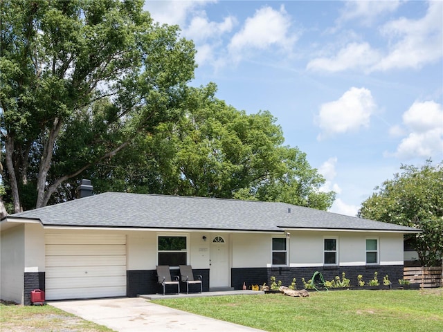 2826 NE 18th Ct, Ocala, FL 34470 - single story home with an attached garage, brick siding, a front yard, concrete driveway, and a shingled roof