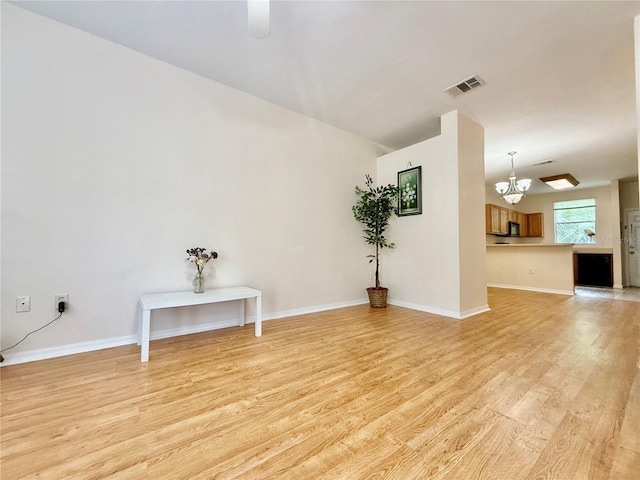 3901 SW 20th Ave Unit 611, Gainesville, FL 32607 - empty room with a chandelier, light wood finished floors, and ceiling fan