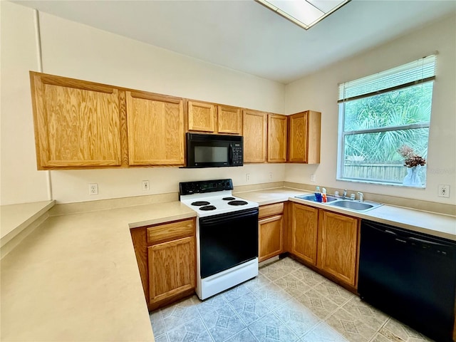 3901 SW 20th Ave Unit 611, Gainesville, FL 32607 - kitchen featuring black appliances, light countertops, and brown cabinetry