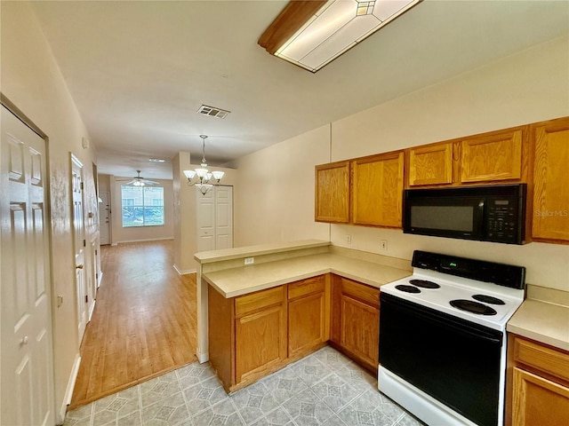 3901 SW 20th Ave Unit 611, Gainesville, FL 32607 - kitchen with black microwave, white range with electric stovetop, a peninsula, brown cabinets, and light countertops