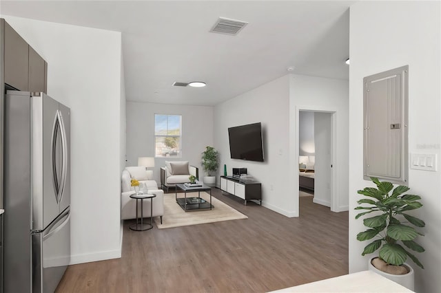 1581 NW 29th Rd Unit 4, Gainesville, FL 32605 - living area with electric panel and wood finished floors