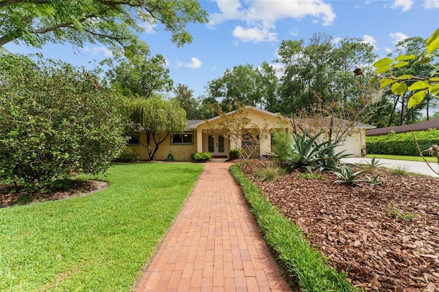 4700 NW 19th Pl, Gainesville, FL 32605 - single story home with french doors, a front lawn, a garage, stucco siding, and concrete driveway