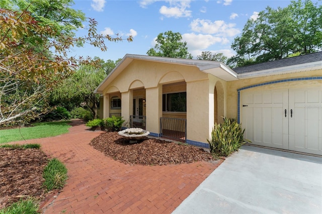 4700 NW 19th Pl, Gainesville, FL 32605 - view of front of house featuring a garage, driveway, and stucco siding