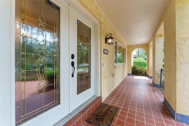 4700 NW 19th Pl, Gainesville, FL 32605 - doorway to property with stucco siding and a porch