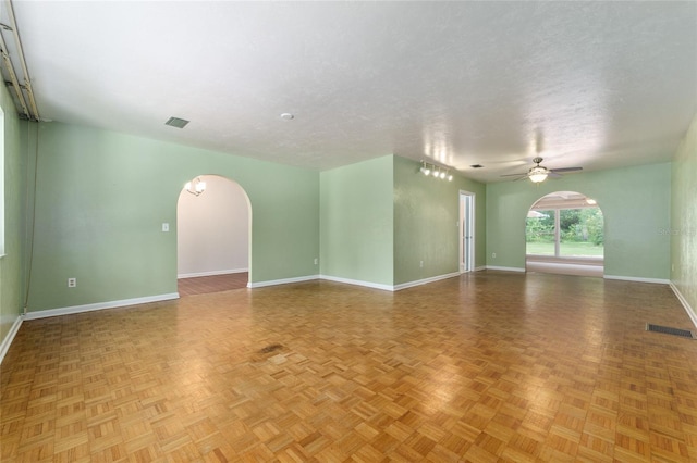 4700 NW 19th Pl, Gainesville, FL 32605 - unfurnished living room featuring arched walkways and a ceiling fan