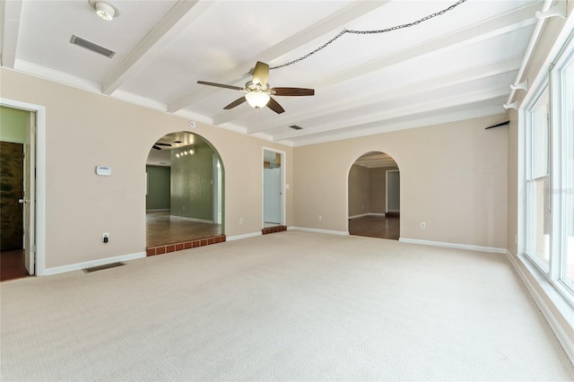 4700 NW 19th Pl, Gainesville, FL 32605 - carpeted empty room featuring arched walkways, beamed ceiling, a ceiling fan, and a smoke detector