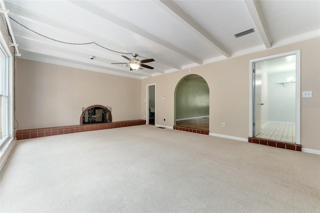 4700 NW 19th Pl, Gainesville, FL 32605 - unfurnished living room featuring beamed ceiling, carpet, a ceiling fan, and arched walkways