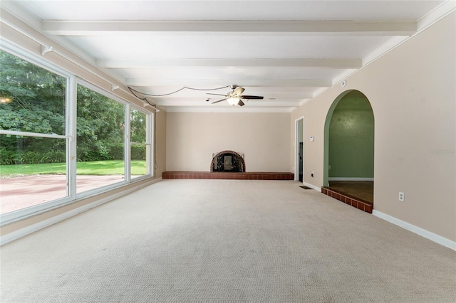 4700 NW 19th Pl, Gainesville, FL 32605 - unfurnished living room featuring beamed ceiling, carpet, ceiling fan, and arched walkways