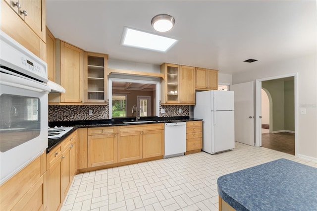 4700 NW 19th Pl, Gainesville, FL 32605 - kitchen featuring white appliances, backsplash, glass insert cabinets, brick patterned flooring, and dark countertops