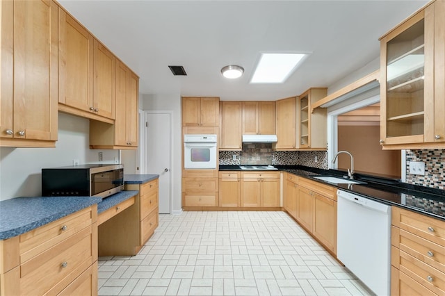 4700 NW 19th Pl, Gainesville, FL 32605 - kitchen with white appliances, under cabinet range hood, light brown cabinets, and backsplash