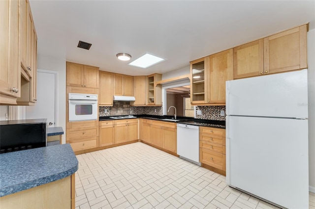 4700 NW 19th Pl, Gainesville, FL 32605 - kitchen with white appliances, light brown cabinetry, tasteful backsplash, and glass insert cabinets