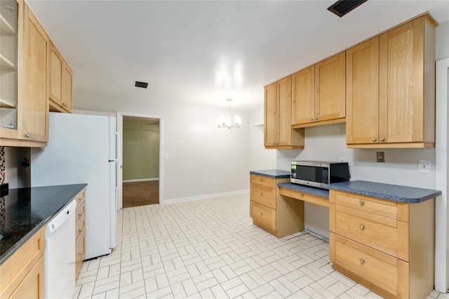 4700 NW 19th Pl, Gainesville, FL 32605 - kitchen featuring white appliances, built in desk, dark countertops, and brick patterned floors