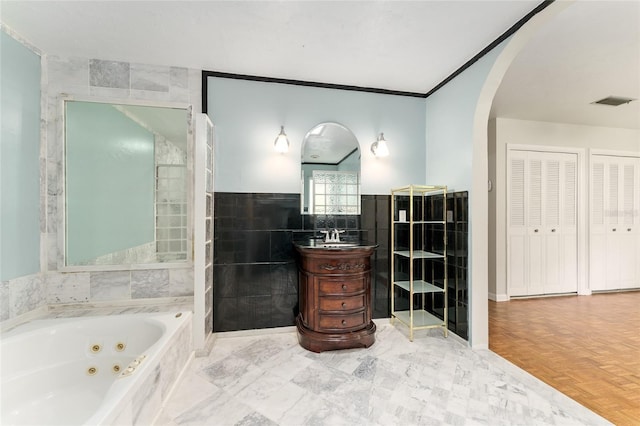 4700 NW 19th Pl, Gainesville, FL 32605 - full bath with a jetted tub, vanity, and tile walls