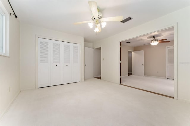 4700 NW 19th Pl, Gainesville, FL 32605 - unfurnished bedroom with carpet floors, a closet, and a ceiling fan