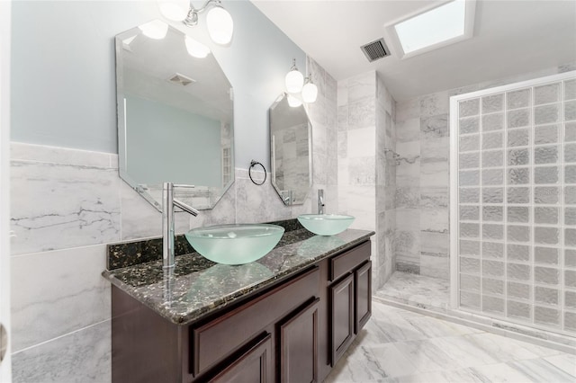4700 NW 19th Pl, Gainesville, FL 32605 - bathroom with tile walls, double vanity, and tiled shower