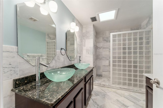 4700 NW 19th Pl, Gainesville, FL 32605 - full bath featuring tile walls, double vanity, a walk in shower, and marble finish flooring